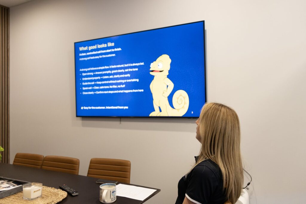 Smartfix customer service training session with a process slide on screen